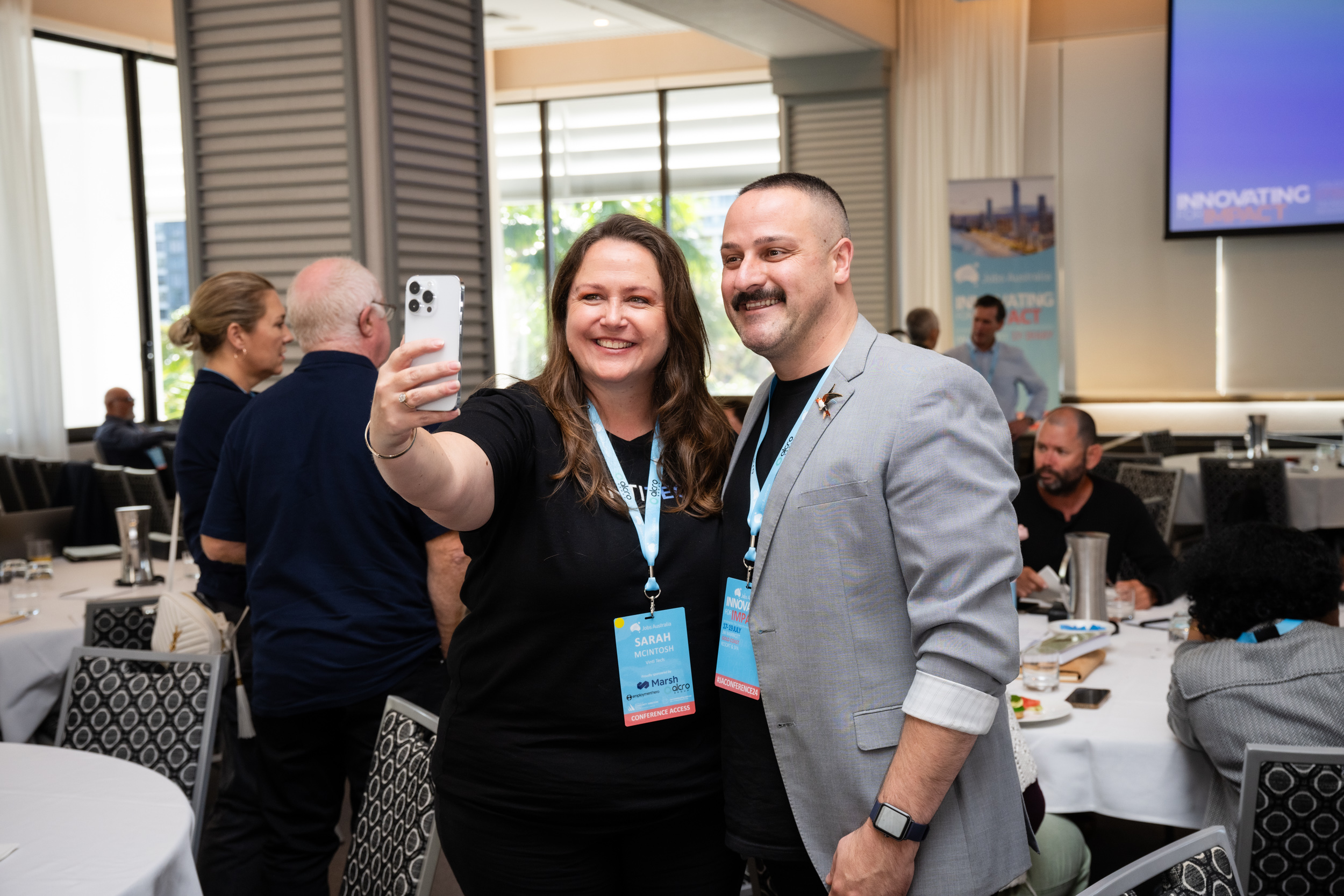 two people taking selfie at conference